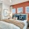 a bedroom with a bed and a fan