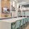 a kitchen with a bar and chairs