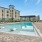 a pool in a courtyard with buildings in the background
