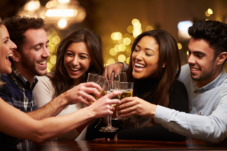 Group Of Friends Enjoying Evening Drinks In Bar smiling 