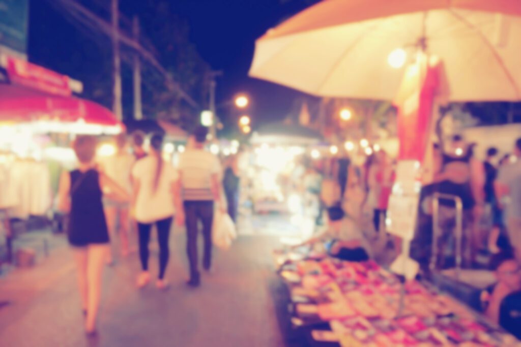 vintage photo effect of blurred people walking at night market