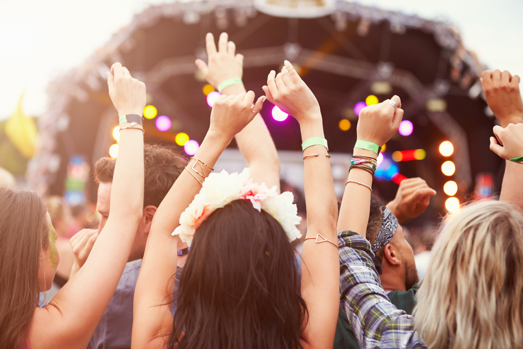 Audience with hands in the air at a music festival