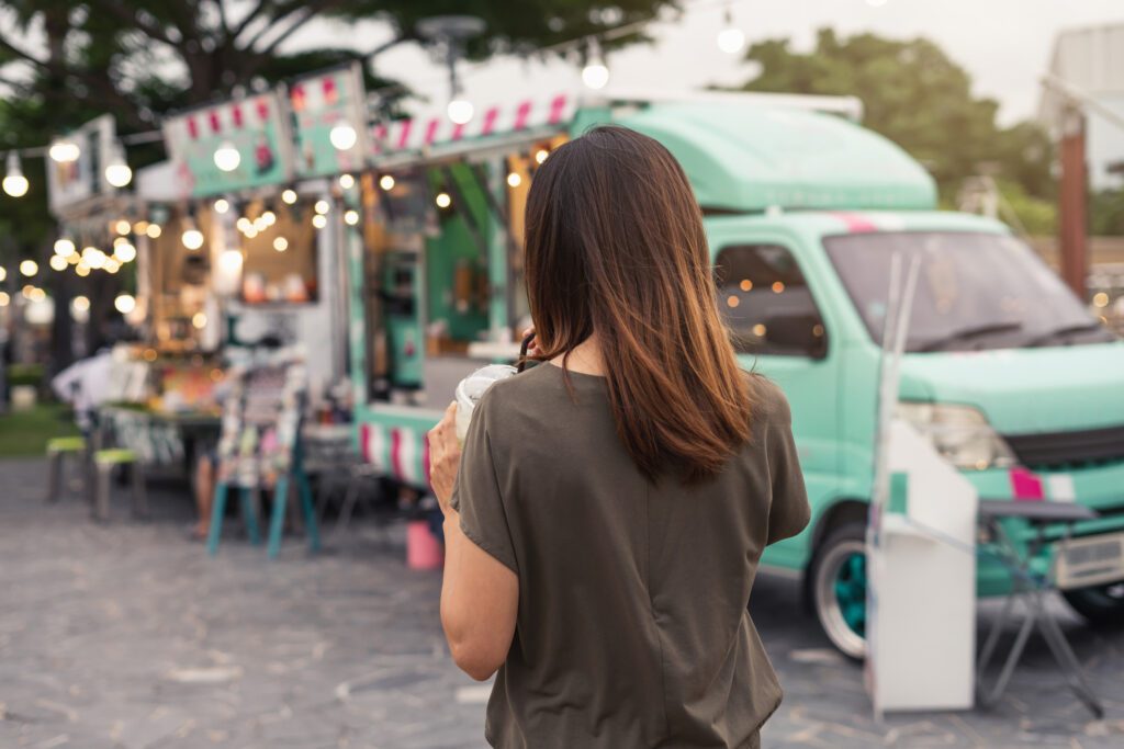 Young woman walking in the food truck market